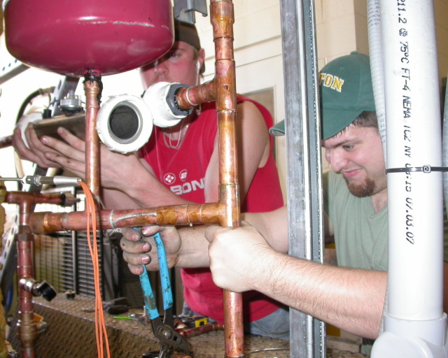 Shaun and his flatmate, working on the pipes